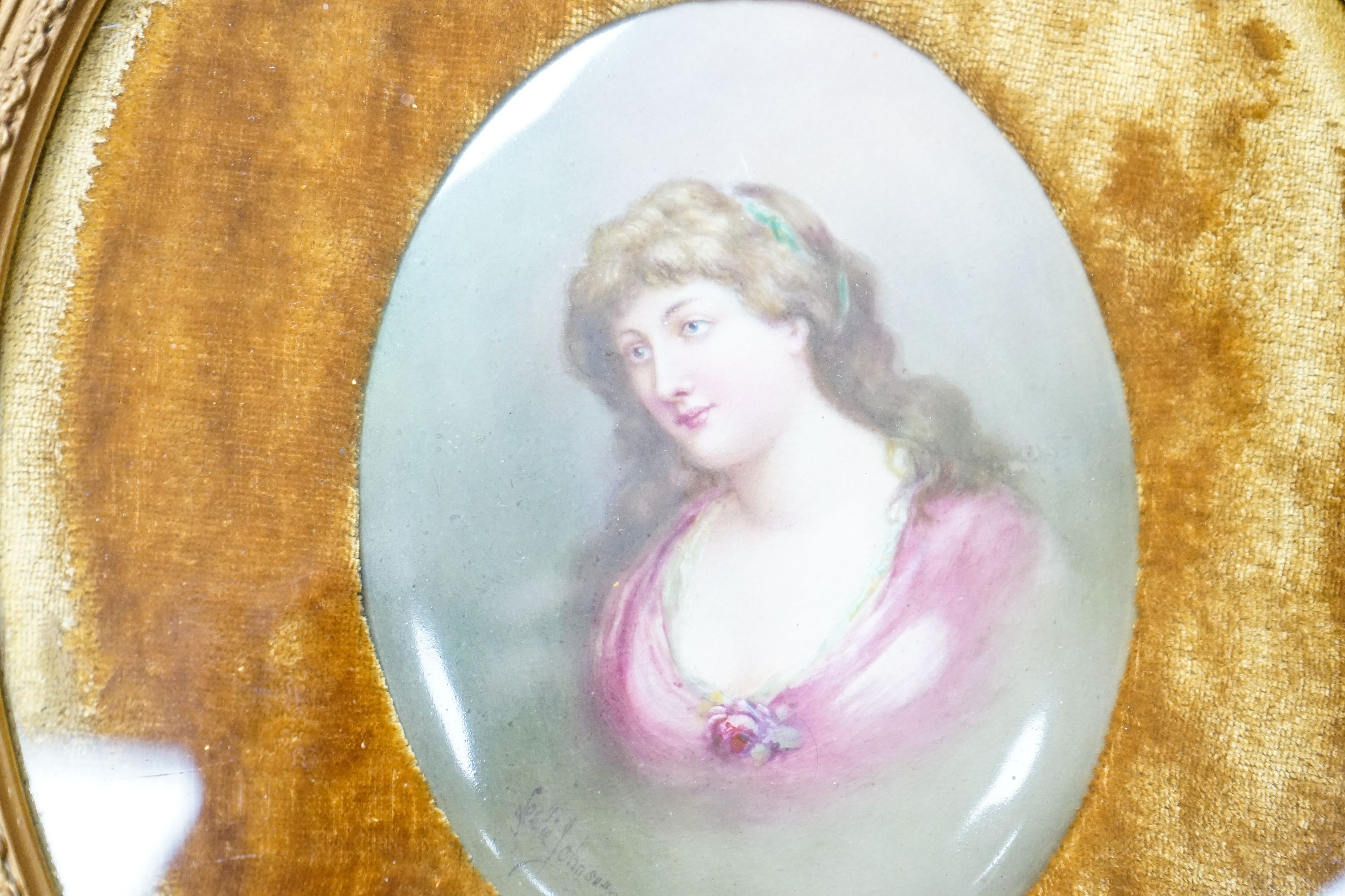 A Royal Doulton oval plaque, signed Leslie Johnson, hand painted with a portrait of a lady, in gesso frame, with velvet mount.